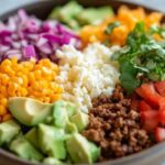 taco bowl recipe 9 A refreshing margarita served alongside a taco bowl with guacamole, cilantro, and a wedge of lime.