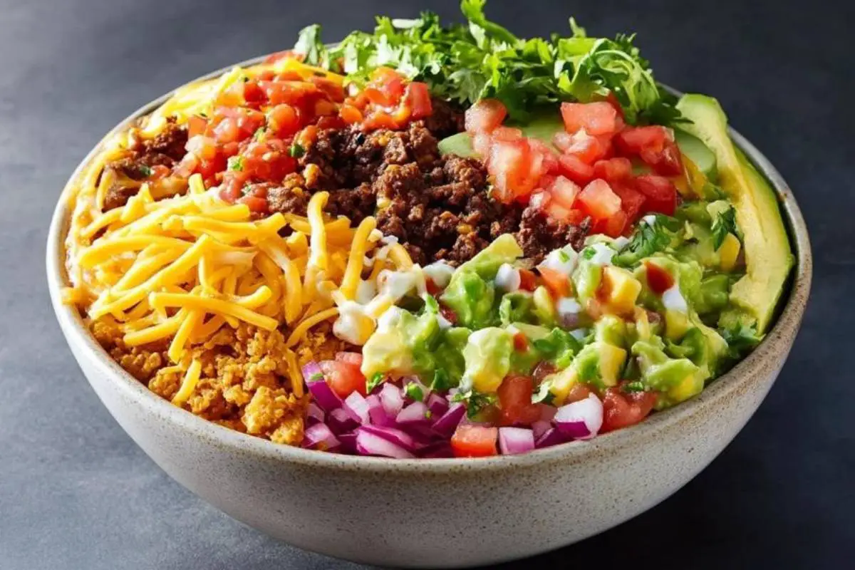 What ingredients are in a Taco Bell Power bowl? 1 "Taco Bell Power Bowl with grilled chicken, black beans, rice, guacamole, and fresh vegetables in a bowl"