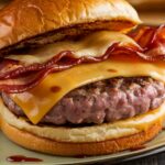 Cheesy Bacon Burger Bliss 7 Cheesy bacon burger with crispy bacon, melted cheese, and a juicy patty on a toasted bun.