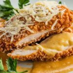 Crunchy Chicken with Parmesan Sauce 5 Crispy breaded chicken topped with creamy Parmesan sauce. Perfectly golden and delicious.