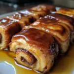 Cinnamon Roll French Toast Roll-Ups 5 Golden brown cinnamon roll French toast roll-ups with crispy exterior and gooey cinnamon-sugar filling.