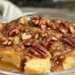 Pecan Pie Bread Pudding 7 Delicious pecan pie bread pudding served with whipped cream, showcasing the rich texture of custard and crunchy pecans.