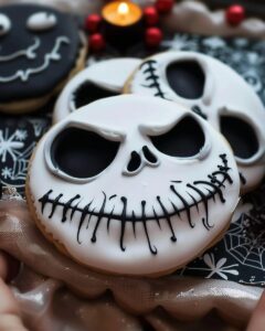 Jack Skellington Halloween sugar cookies decorated with spooky faces on a cooling rack