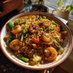 A colorful bowl of 3-ingredient ramen stir-fry with shrimp, vegetables, and noodles.