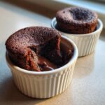 Close-up of a 4-Ingredient Nutella Lava Cake with molten chocolate center in a white ramekin.