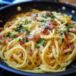 Close-up of 5-Minute Lazy Girl Pasta with Garlic Parmesan in a pan, garnished with parsley and bacon.