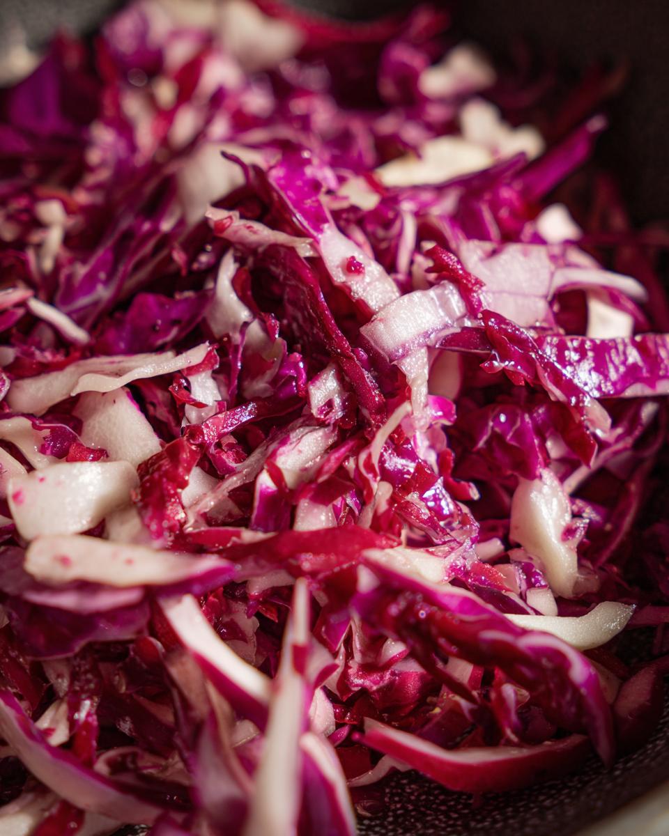Close-up of freshly chopped red cabbage, ready for the Apple Cranberry Coleslaw recipe.