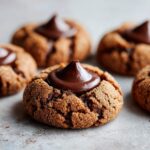 Close-up of a freshly baked Gingerbread Kiss Cookie, topped with a melted chocolate Hershey's Kiss.