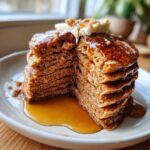 Stack of fluffy Gingerbread Pancakes with butter and syrup, perfect for breakfast. Featuring the Gingerbread Pancake Stack.