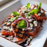 Close-up of a Grilled Watermelon Feta Salad with feta cheese, red onion, and mint.
