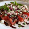 Close-up of Grilled Watermelon Feta Salad with feta cheese, red onion, and mint.