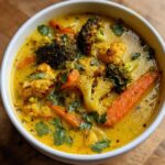 Close-up of a bowl of Immune-Boosting Turmeric Veggie Soup with broccoli, cauliflower, and carrots.