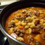 Close-up of a pot filled with One-Pot Pasta e Fagioli Soup, showing pasta, beans, and meat.