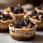 Close-up of a Peanut Butter Oreo Fudge Cup with Oreo cookie crumbles on top.
