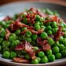 Close-up of a plate of Peas with Pancetta, a quick and easy recipe.