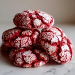 A close-up stack of delicious Red Velvet Crinkle Cookies dusted with powdered sugar.