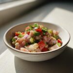Close-up of a bowl of Simple Tuna and White Bean Salad with tuna, white beans, and fresh vegetables.
