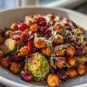 Close-up of Spicy Roasted Chickpeas Brussels Sprout Salad with cranberries and parmesan cheese.