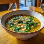 A bowl of delicious Tuscan White Bean & Spinach Soup, ready to eat.