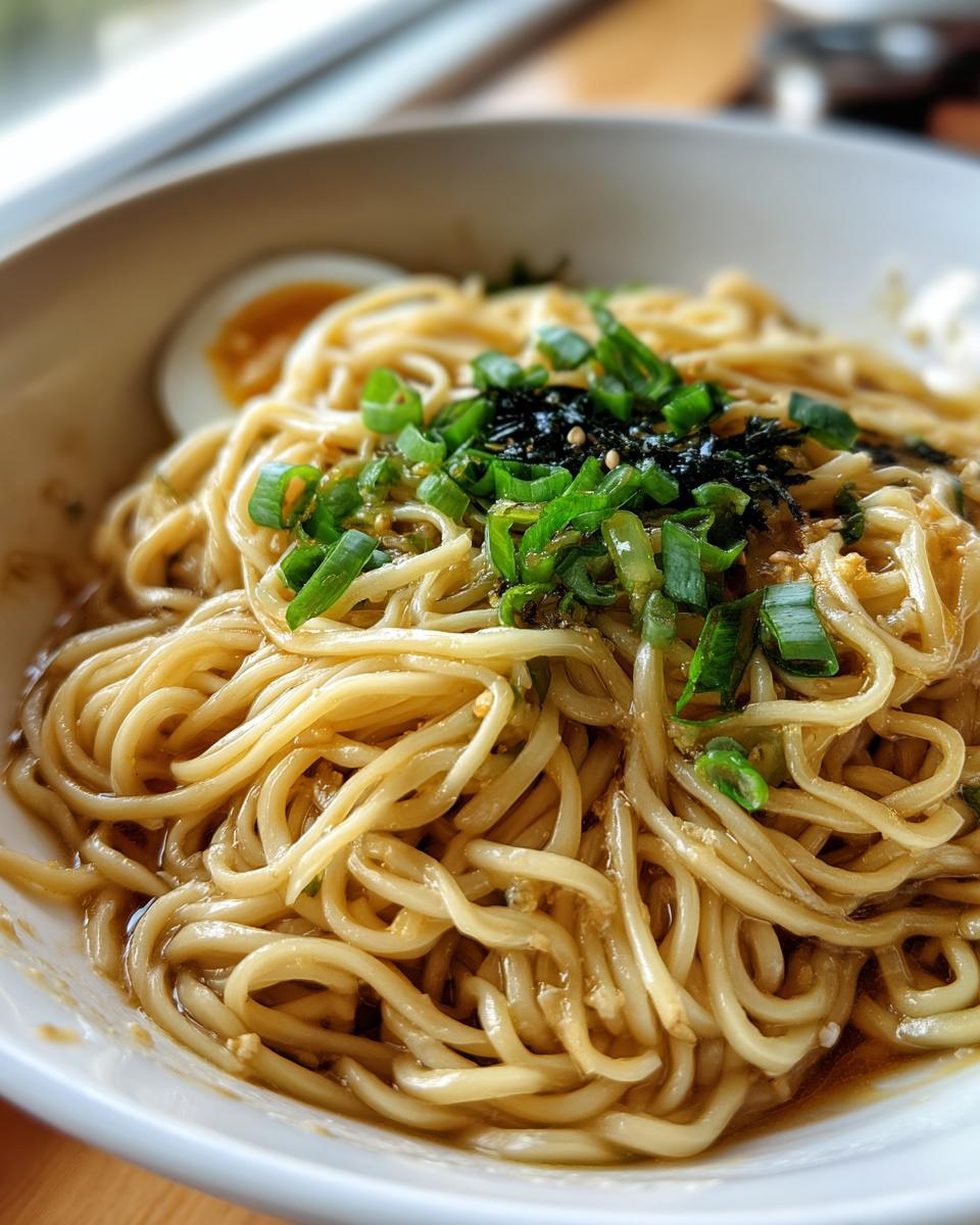 Upgraded Ramen Bowl: 10-Minute Deliciousness! 7 Close-up of an Upgraded Ramen Bowl with Garlic Butter, garnished with green onions and seaweed.