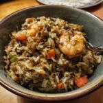 Close-up of a bowl of delicious wild rice pilaf with shrimp and vegetables.