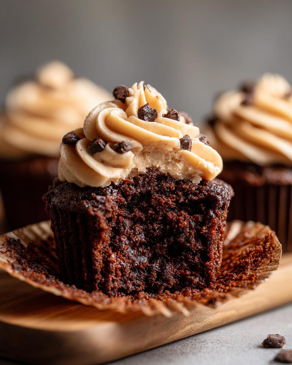 Close-up of a Chocolate Guinness Cupcake with frosting and chocolate chips.