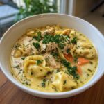 Creamy Chicken Tortellini Soup: 3 Steps to Comfort 11 Close-up of a bowl of creamy chicken tortellini soup with chicken, tortellini, and carrots.