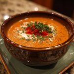 Amazing! Easy Stuffed Pepper Soup: 3 Steps to Delight 11 Close-up of a bowl of Easy Stuffed Pepper Soup, garnished with red peppers and herbs.