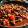 Close-up of a bowl of Guinness Beer Chili with beans, meat, and vegetables.