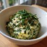 Close-up of herb butter in a white bowl, perfect for Vegetarian Colcannon Soup.
