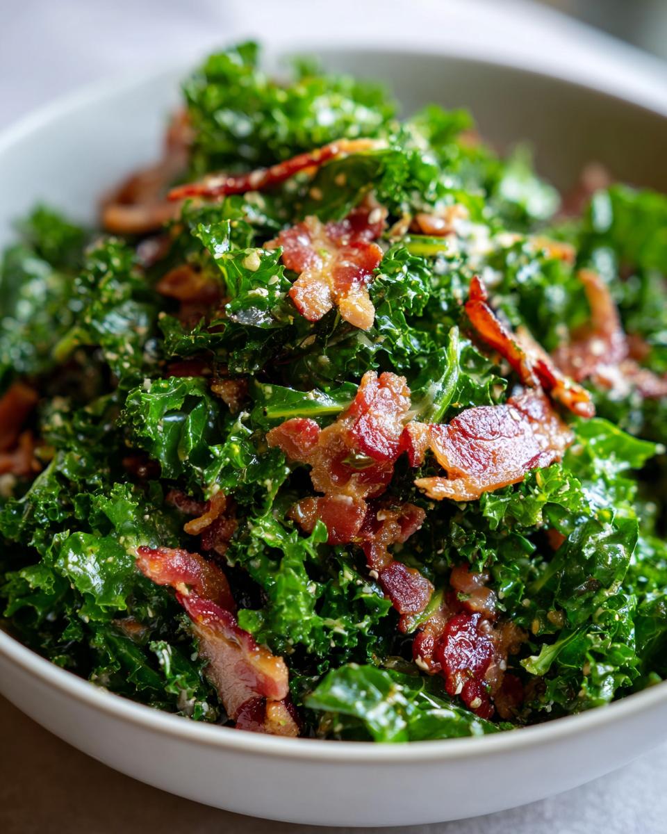 Close-up of a bowl of fresh Kale and Bacon Salad, with crispy bacon and a light dressing.