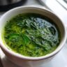 Close-up of a bowl of delicious Spinach and Herb Broth, a healthy and flavorful soup.