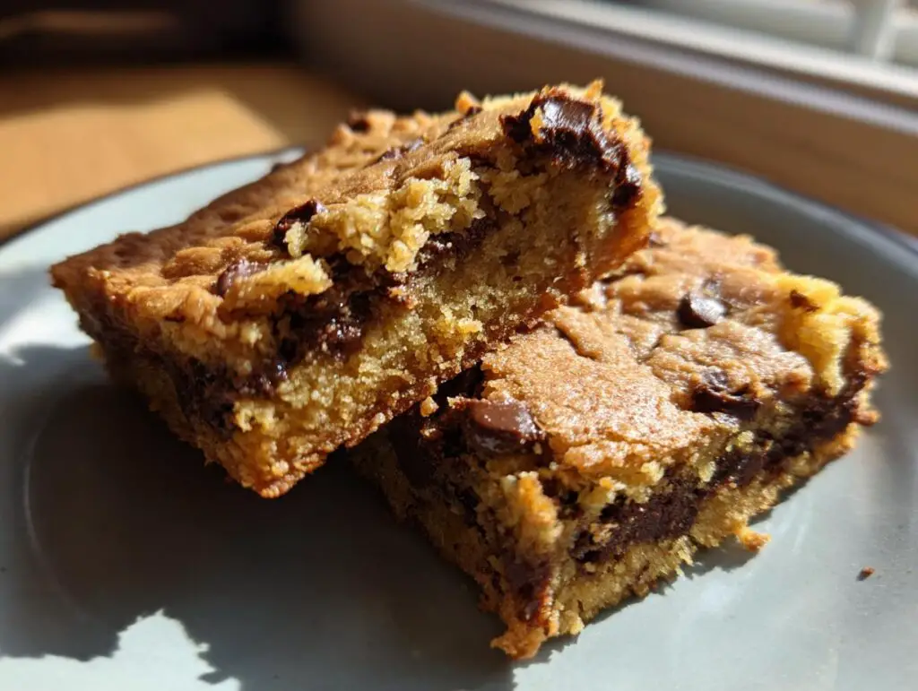 Close-up of two chocolate chip bars, showing the texture and chocolate filling. These Bars Are Better Than Brownies.
