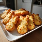 Adorable Easter Bunny-Shaped Cat Treats 11 A plate of golden, baked Easter Bunny-Shaped Cat Treats, ready for your feline friend.