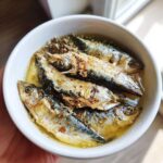 Amazing Fresh Sardine Cat Dinner: 1 Happy Cat 11 Close-up of a white bowl filled with fresh sardines, prepared for a Fresh Sardine Cat Dinner.