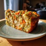 Amazing Homemade Cat Birthday Cake in 15 Mins 11 A slice of delicious Homemade Cat Birthday Cake with vegetables and chicken, served on a plate.