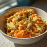A bowl of a homemade Indoor Cat Weight Control Meal with shredded chicken and carrots.