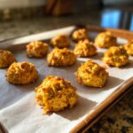 Close-up of baked Soft Senior Cat Treats on a parchment-lined baking sheet.