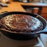Close-up of a freshly baked Southern Chocolate Cobbler in a cast iron skillet.
