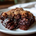 A slice of delicious Southern Chocolate Cobbler on a white plate, close-up.