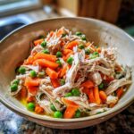 Spring Chicken Cat Meal Bowl: 1 Simple, Healthy Dish 11 Close-up of a Spring Chicken Cat Meal Bowl with shredded chicken, carrots, and peas.