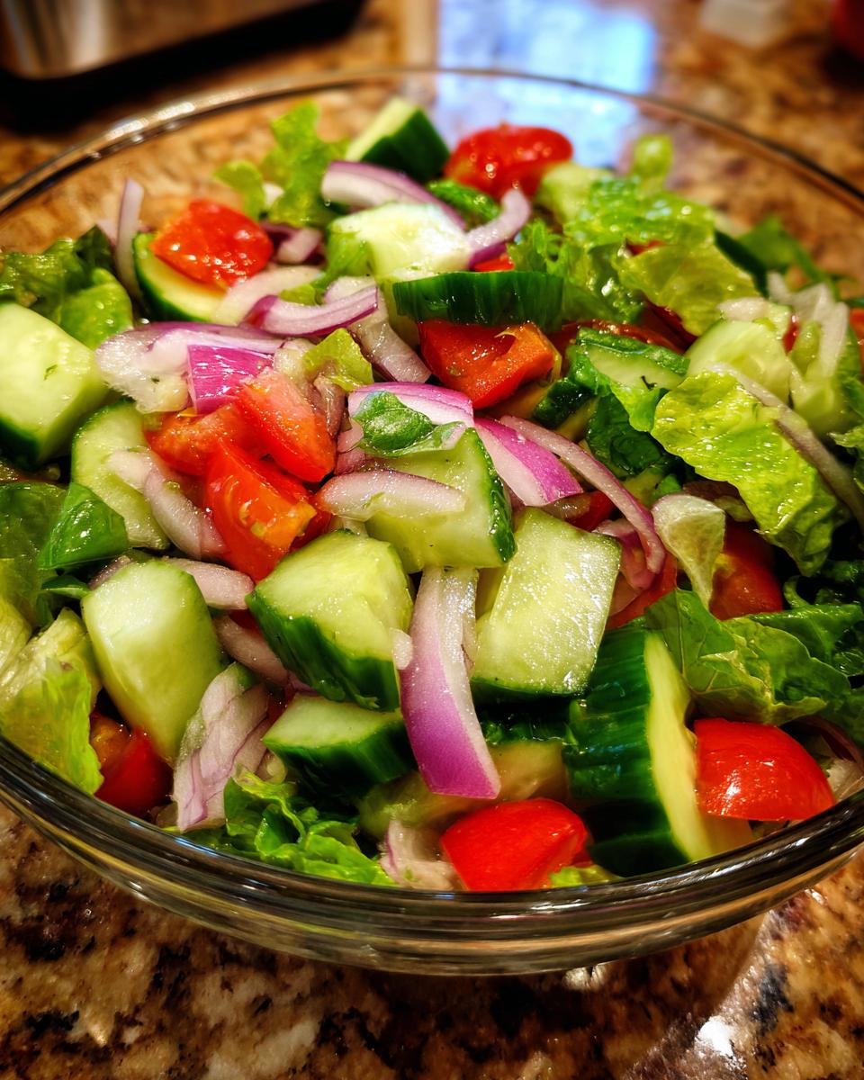 18 Best 15-Minute Salad Recipes: Deliciously Fast 9 Close-up of a fresh salad with cucumbers, tomatoes, red onion, and lettuce; perfect for a 15-Minute Salad.