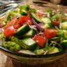 Close-up of a fresh salad bowl with tomatoes, cucumbers, and red onion, perfect for a 15-minute salad.
