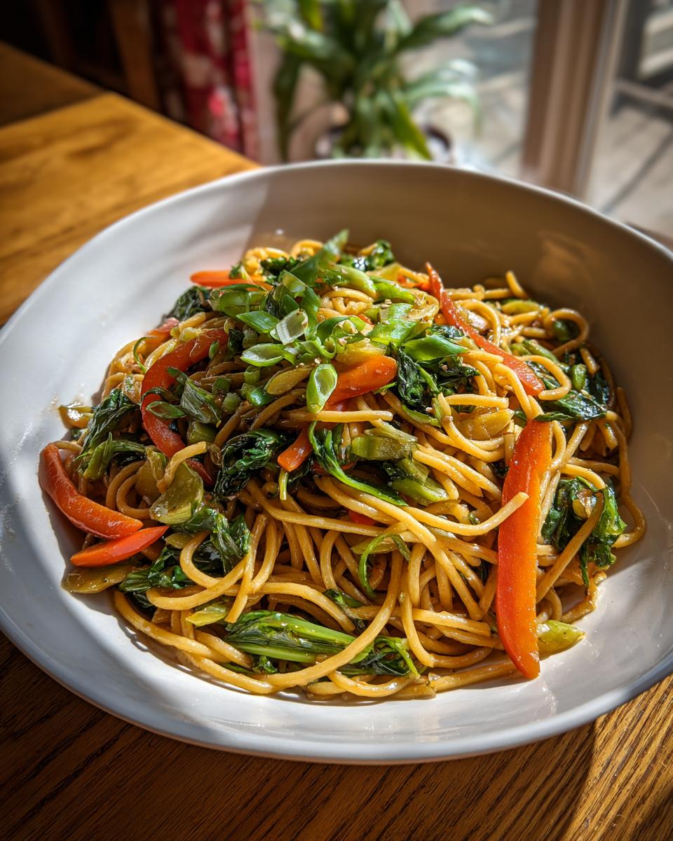 Amazing Asian Pasta Salad: 1 Flavor Bomb 7 Close-up of a bowl of Asian pasta salad with noodles, vegetables, and green onions.