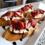 Close-up of Burrata & Strawberry Crostini, a tasty appetizer.