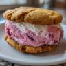 Close-up of a Cherry Vanilla Ice Cream Sandwich on a white plate.