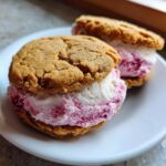 Two Cherry Vanilla Ice Cream Sandwiches on a white plate, close-up.