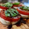 Close-up of a Classic Caprese Salad with tomato, mozzarella, basil and aged balsamic.