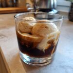 A refreshing Cold Brew Affogato with vanilla ice cream in a glass.