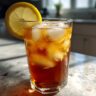 A glass of refreshing Cold Brew Lemonade with ice and a lemon slice garnish.